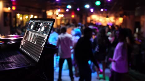 a vibrant dynamic scene showcasing a dj setup with an energetic crowd joyfully dancing under colorful lights
