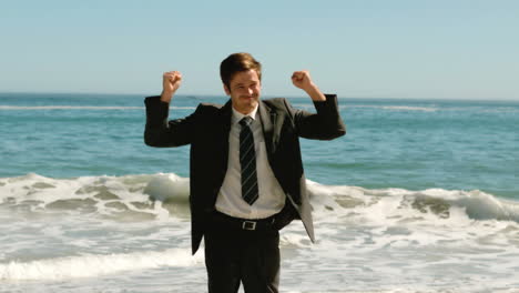 joyful businessman on the beach