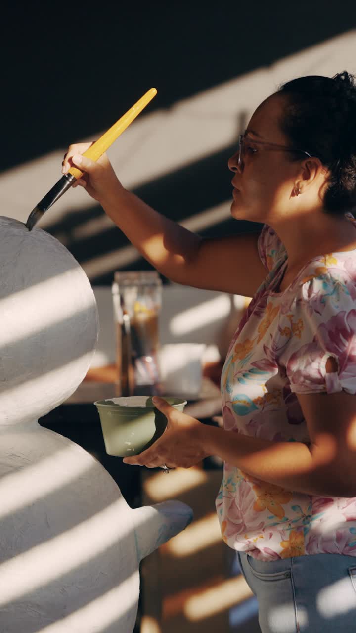 Woman painting a craft project