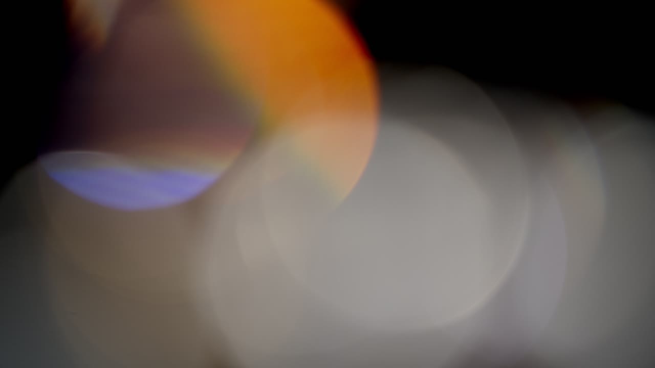 Multicolored light leaks footage on black background, lens flare leak burst overlays transitions
