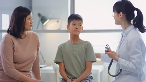 asian tween boy on health checkup in clinic