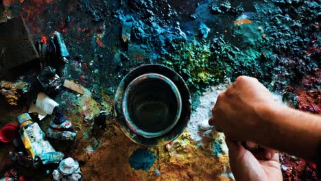 artist painter adding white paint to his palette