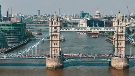 timelapse aerial approach to tower bridge during london marathon with busy river traffic