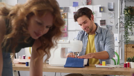 male and female students or business owners working in fashion studio together