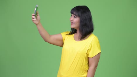 beautiful asian woman video calling with phone
