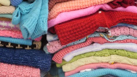 colorful stack of knitted sweaters