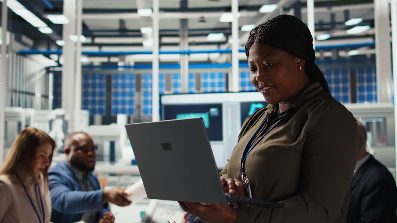 Happy Solar Panels Facility Engineer Using Laptop To Improve Efficiency