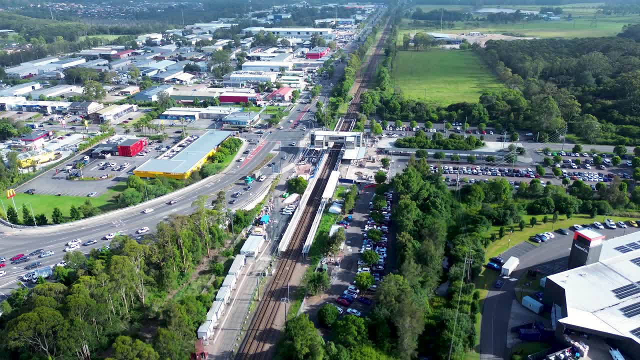 Drone aerial landscape of Tuggerah neighbourhood town centre outdoors with car vehicles on main road street Central Coast Australia traffic transport urban infrastructure highway