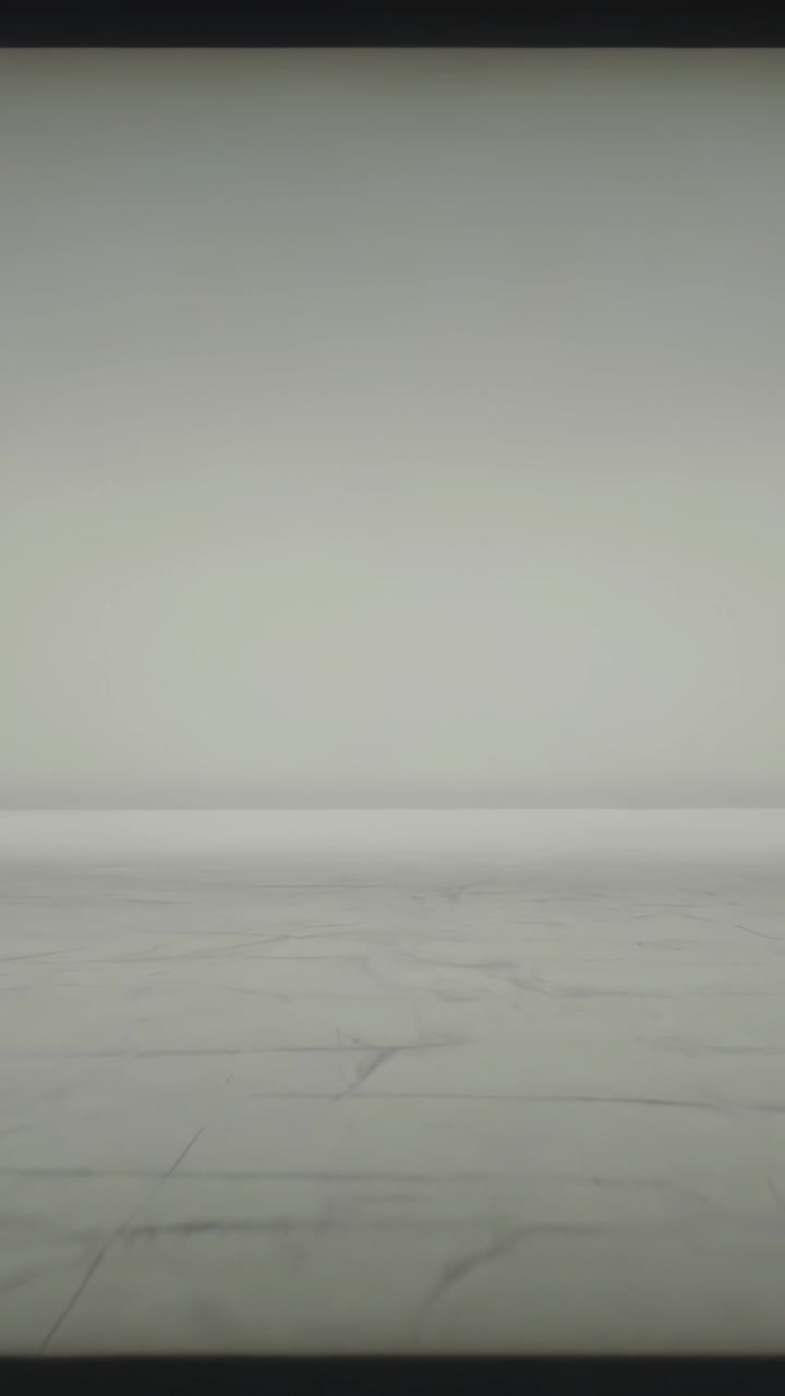 Vertical video: Recording vertical camera capturing low-angle pale wall and floor for texture study