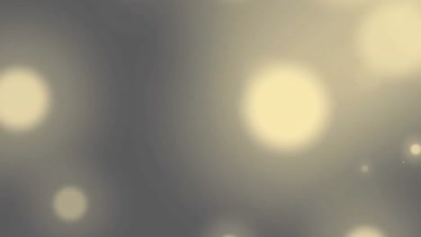Animation-of-glowing-yellow-spots-of-light-on-grey-background