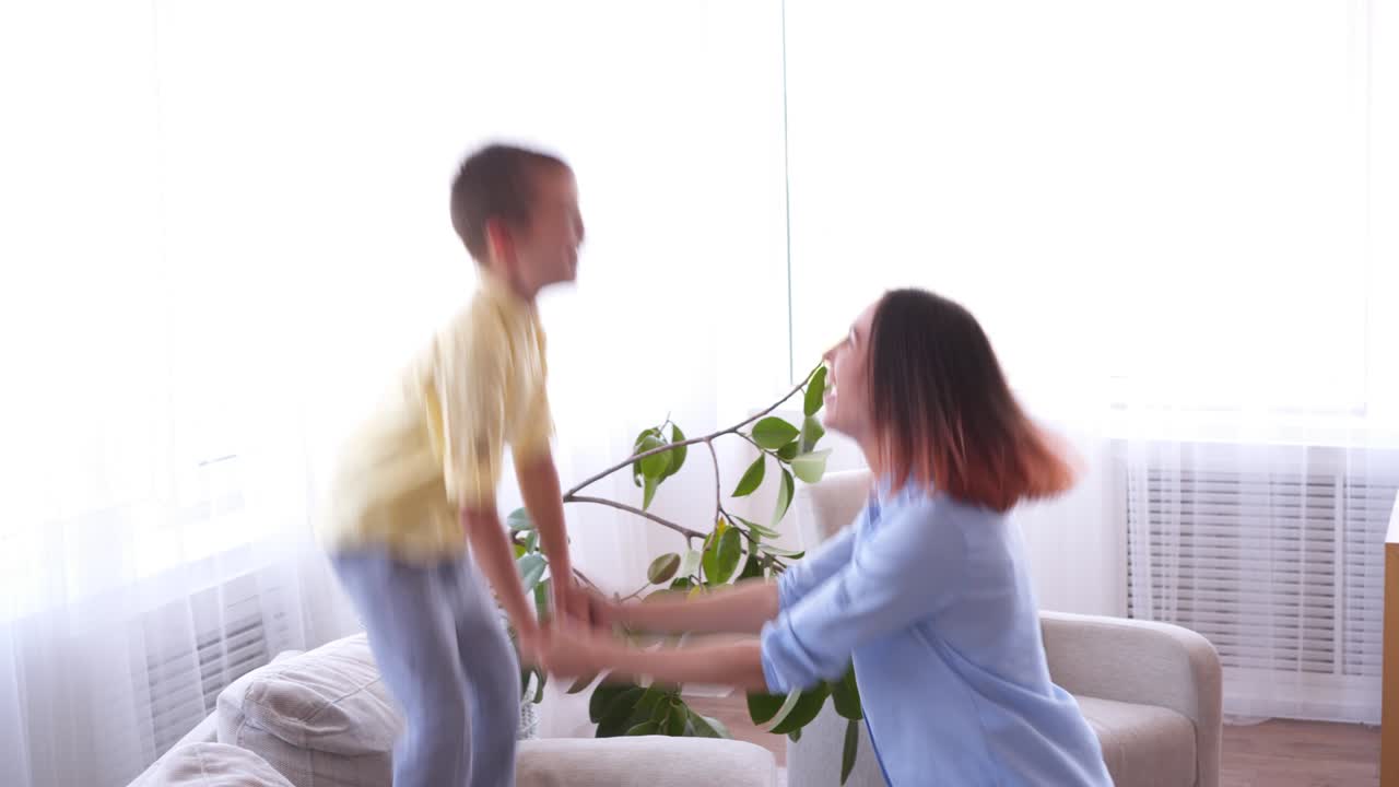 Cheerful mother with son having fun at home