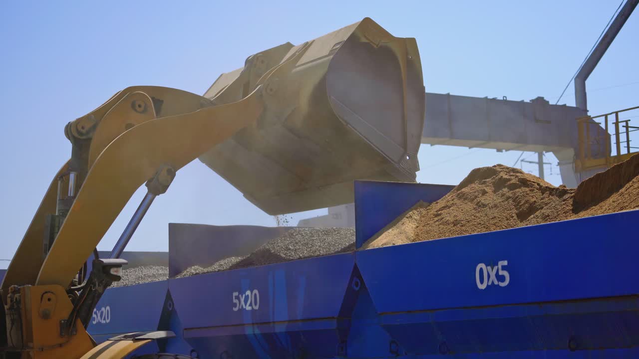 Equipment for production of asphalt. Asphalt mixing plant pouring asphalt in to truck in factory industrial