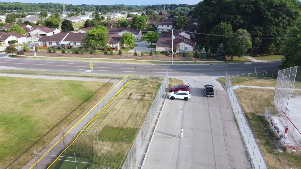 A pickup truck pulls out of a parking lot.