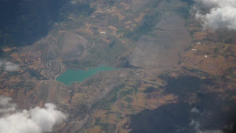 aerial view of a turquoise lake and mountainous landscape