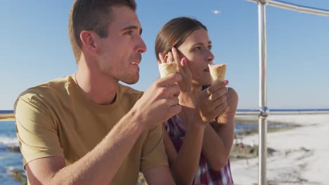 Young-adult-couple-relaxing-at-the-seaside