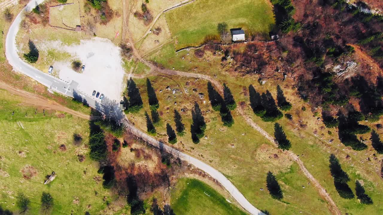 Aerial descending over a small road near Bohinj lake in Triglav National Park, Slovenia