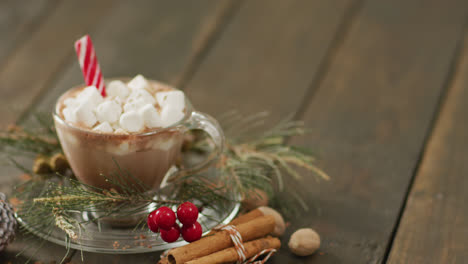 Video-of-cup-of-hot-chocolate-with-marshmallows-over-wooden-background