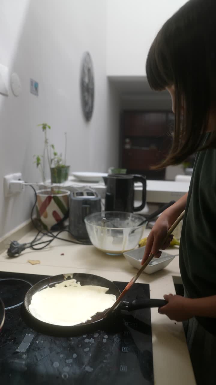 A Child Cooking Pancakes