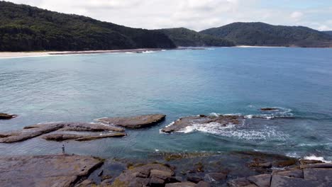 aerial drone landscape shot of depot beach coastline bay headland rocky ocean reef bushland durras pebbly beach nsw south coast travel tourism australia 4k