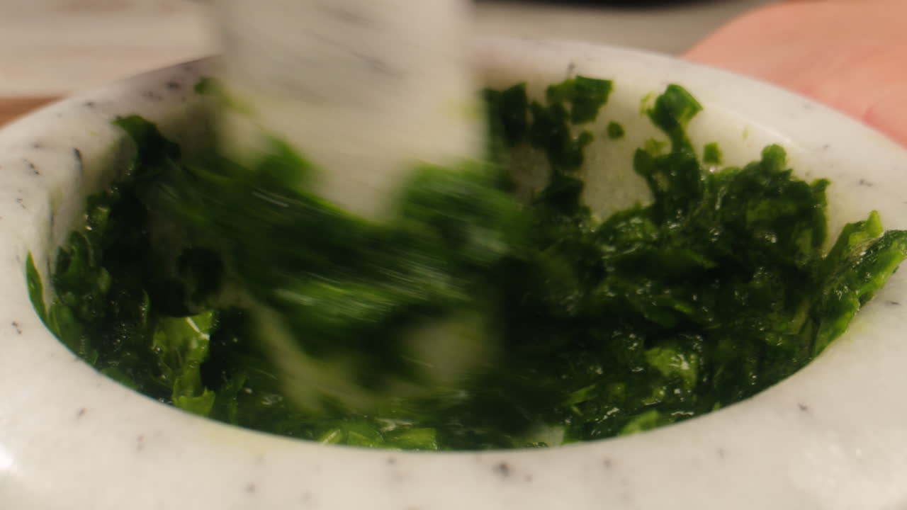 Making pesto with mortar and pestle
