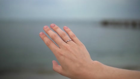 newly engaged person looking at ring on finger