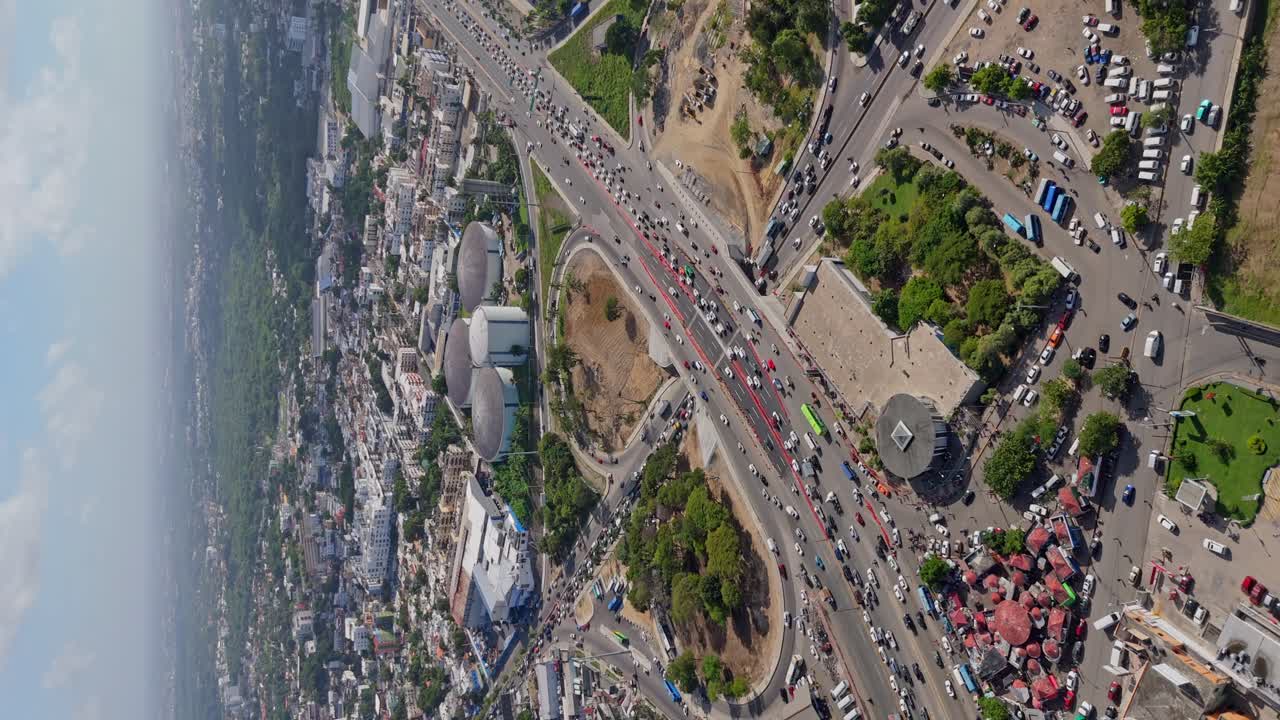 Kilometer 9 of Duarte highway and surrounding landscape, Santo Domingo city, Dominican Republic. Aerial drone and vertical format