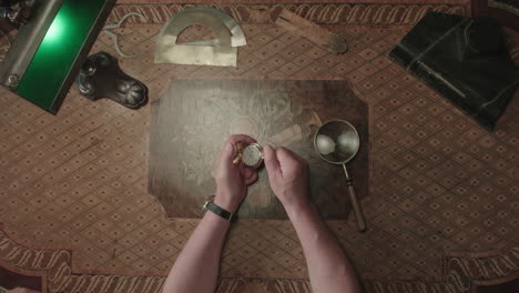 an older man evaluates an antique watch