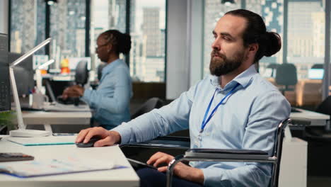 portfolio manager in wheelchair looks over documentation files