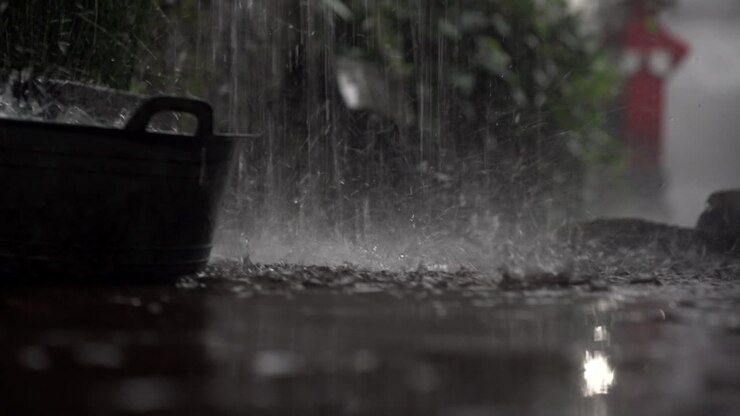Torrential rain hitting hard concrete floor, Balinese house backyard, Close-up shot