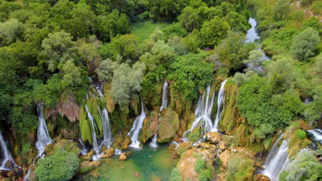 aerial of large tufa cascades - kravica waterfall on the trebizat river in bosnia and herzegovina