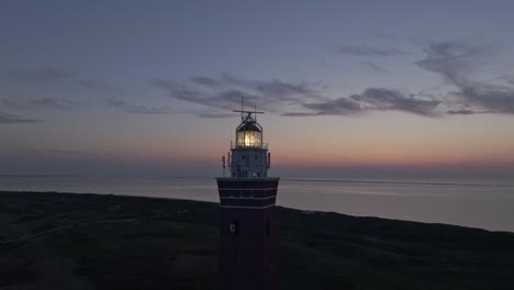 fly around the lighthouse westhoofd in nature landscape near ouddorp shoreline, aerial