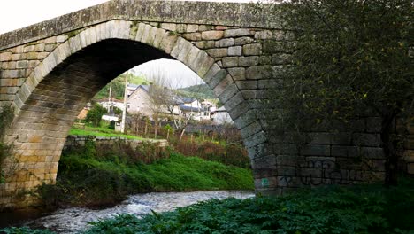 historic stone bridge with unique arched masonry as water flows below from lonia river