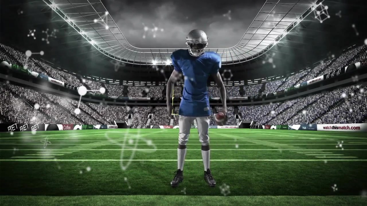 Football player entering field while viewing phone then starting warm-up with molecular graphics
