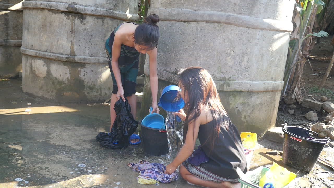 Women Washing Clothes Outdoors