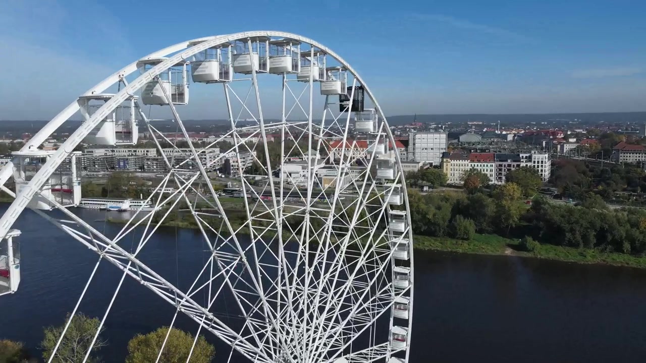 En drone sirkler rundt et pariserhjul nær Elben med Arcotel HafenCity i bakgrunnen.