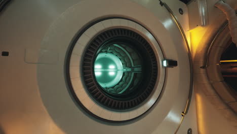 interior view of a space station airlock with glowing core in orbit