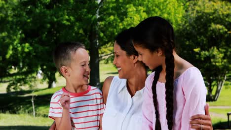 Mother-interacting-with-her-son-and-daughter-in-park