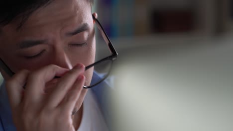 young asian businessman looking serious and stressed while using laptop to work from home.