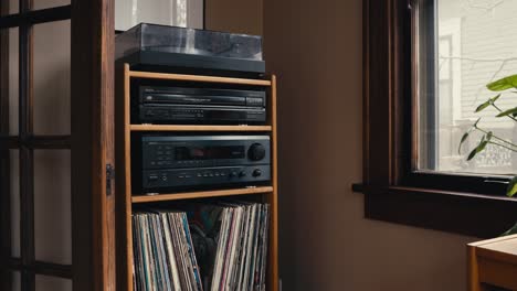 an vintage record player and cd player sitting inside of shelving with records underneath it