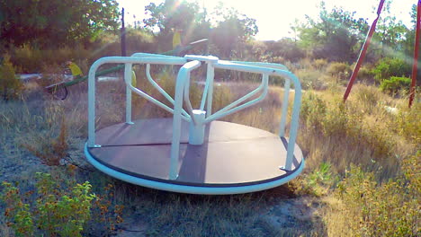 where are all the kids - close up of a round about in a deserted play area