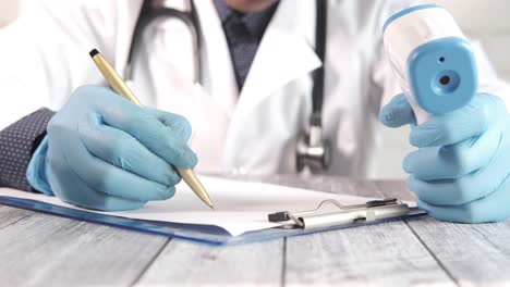 doctor taking patient's temperature and writing a medical record