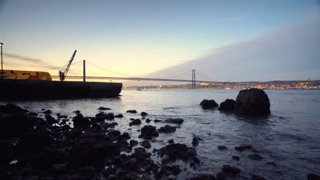 sunset 25th april bridge, lisbon, river tejo, portugal