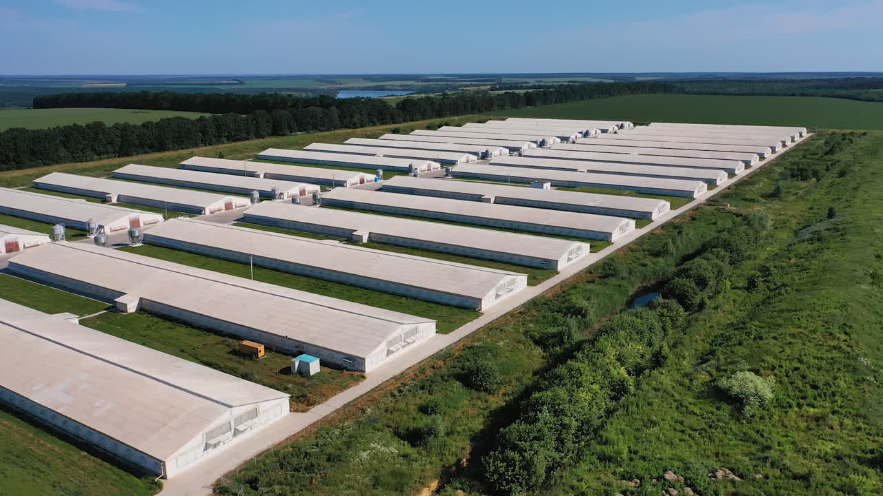 Aerial view of industrial big hangars. Outdoor exterior warehouse building.