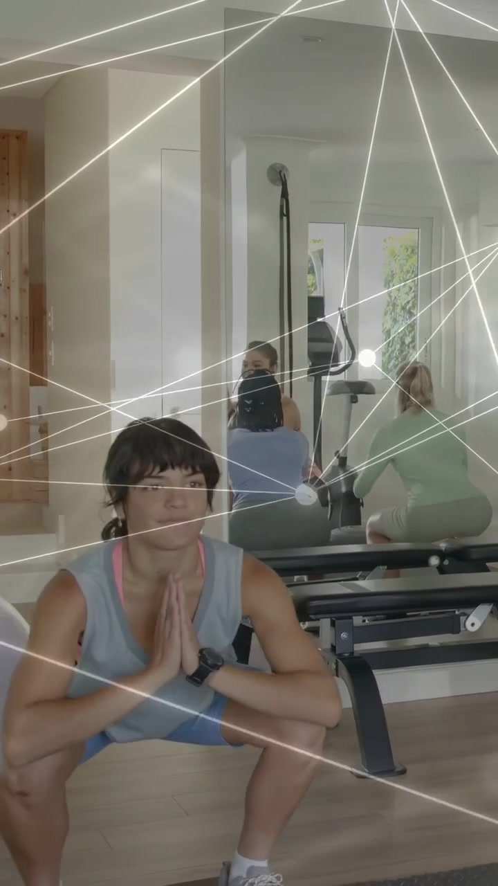 Vertical video: Woman starting squat set, doing fitness reps with overlay tracking motion in mirror