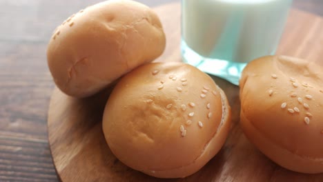 buns and milk on wooden board