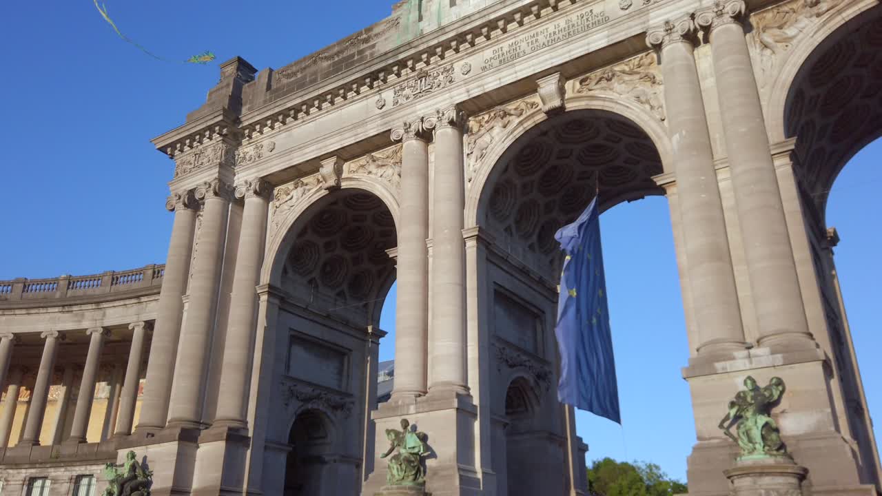 Kite glides above EU flag under Cinquantenaire arch in Brussels