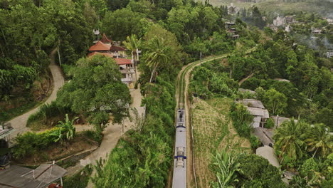 ella sri lanka aerial v18 cinematic drone flyover beside a mountain train, reveals the scenic journey ride with resort hotels nestled amid picturesque hills - shot with mavic 3 cine - april 2023