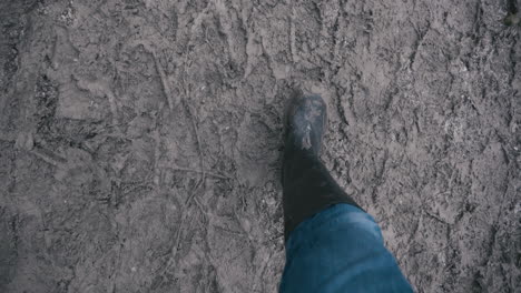 muddy boots walking along a muddy path