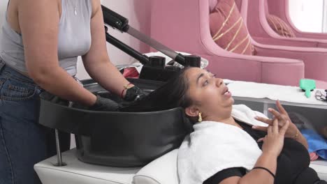 hair care routine for latina woman at modern beauty salon, hair treatment session