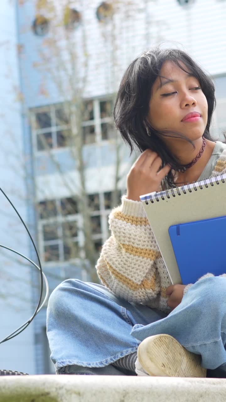 Young Woman with Notebooks Outdoors